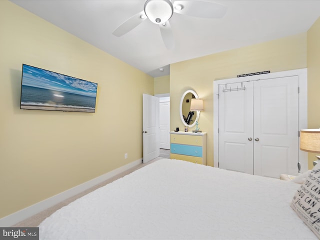 bedroom featuring carpet, a closet, baseboards, and a ceiling fan