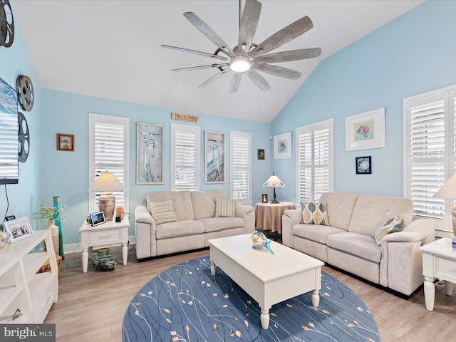 living room with vaulted ceiling, baseboards, a ceiling fan, and light wood-style floors