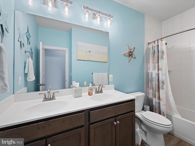 bathroom with shower / tub combo, a sink, toilet, and double vanity