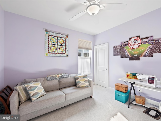 carpeted living room with ceiling fan and baseboards