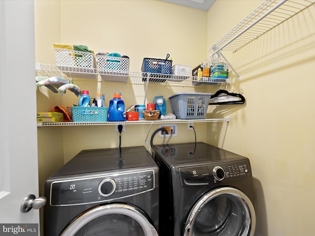 clothes washing area with laundry area and separate washer and dryer