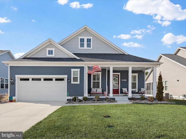 view of front of house with covered porch, concrete driveway, a front lawn, and an attached garage