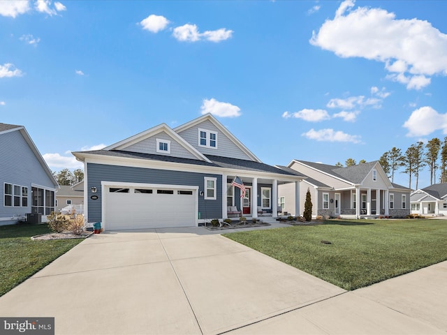 view of front of home featuring a porch, a front yard, concrete driveway, and a garage