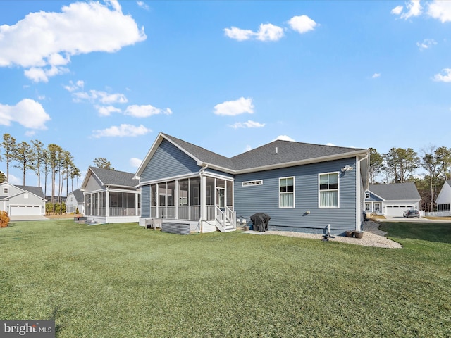 back of property featuring a sunroom and a yard