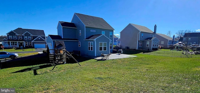 back of property featuring a yard, a residential view, a patio, and fence