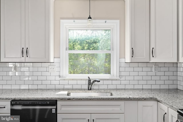 kitchen featuring dishwasher, a sink, tasteful backsplash, white cabinets, and healthy amount of natural light