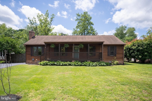 view of front of house with covered porch, crawl space, and a chimney