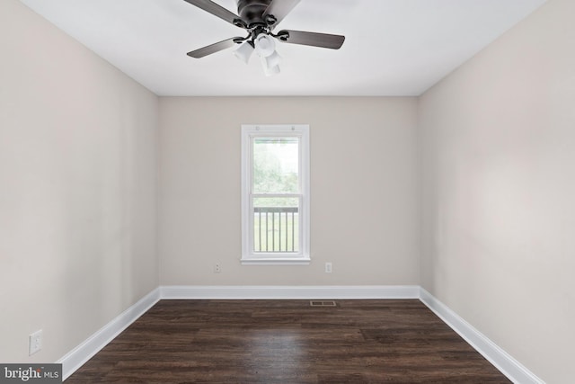 spare room with a ceiling fan, baseboards, and dark wood-style floors