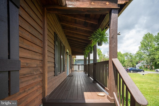 wooden deck with a lawn