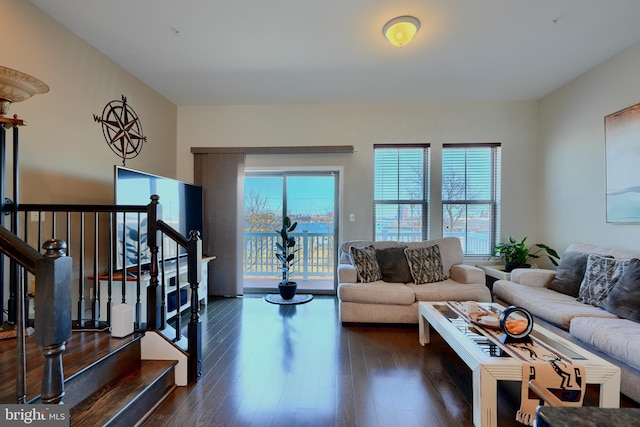 living room with dark wood finished floors and stairs