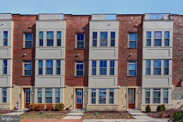 view of front of property featuring brick siding and a residential view