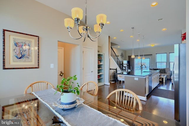 dining room with an inviting chandelier, stairs, dark wood finished floors, and recessed lighting