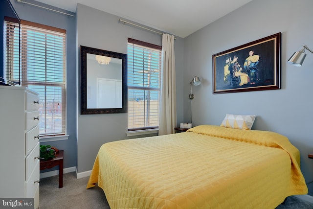 carpeted bedroom featuring baseboards