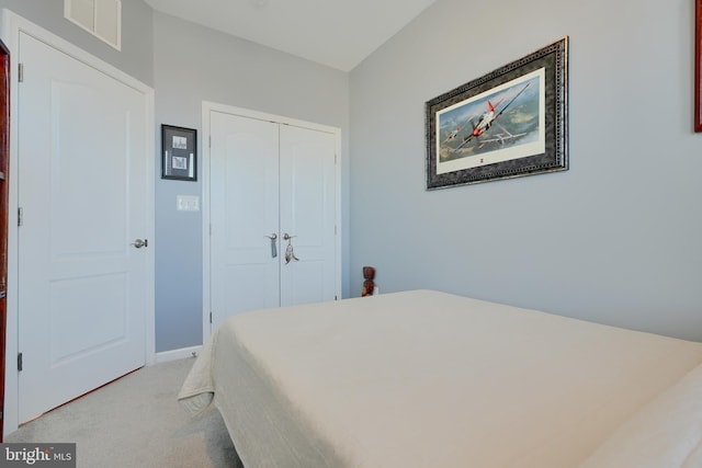 bedroom with light carpet, a closet, and visible vents