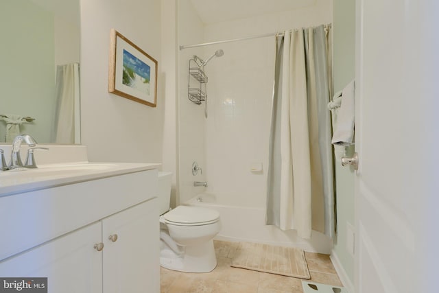 bathroom featuring shower / bath combo with shower curtain, vanity, toilet, and tile patterned floors