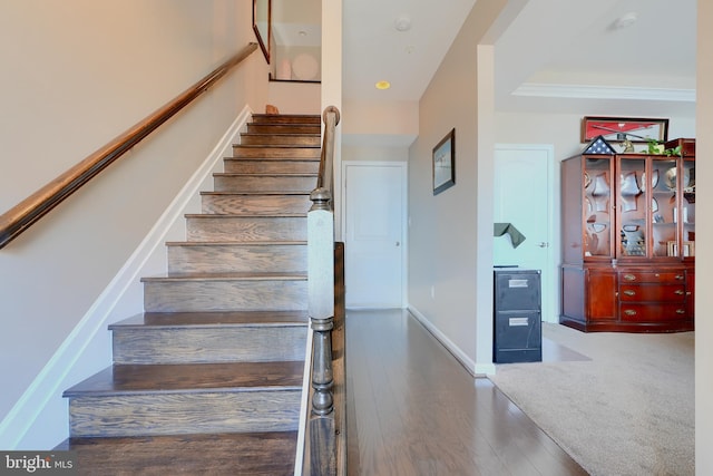 stairway with baseboards and wood finished floors