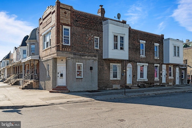 view of front of property featuring entry steps and brick siding