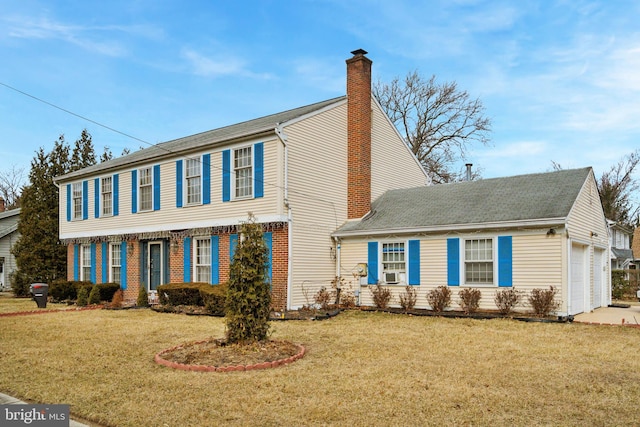 colonial-style house with a chimney, an attached garage, cooling unit, a front lawn, and brick siding