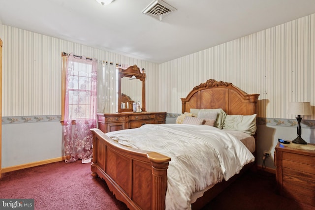 carpeted bedroom with wallpapered walls, baseboards, and visible vents