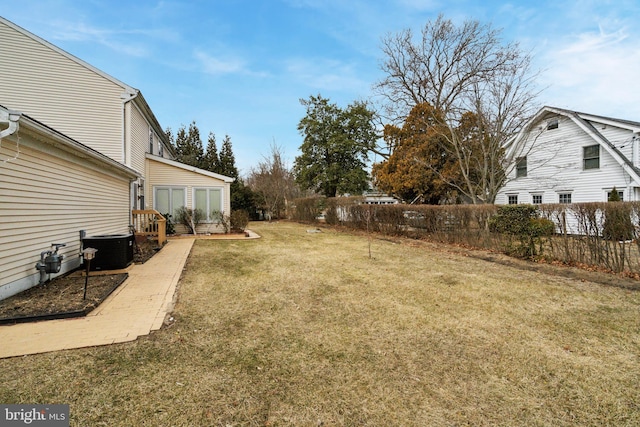 view of yard with fence and central AC