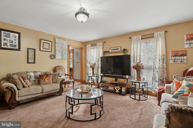 living room featuring light carpet and baseboards