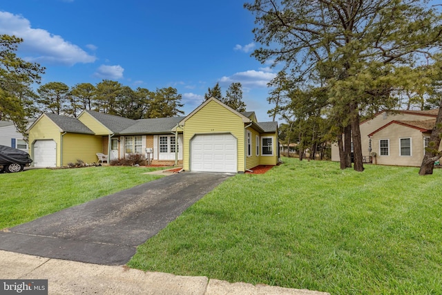 ranch-style home with a garage, a front lawn, and aphalt driveway