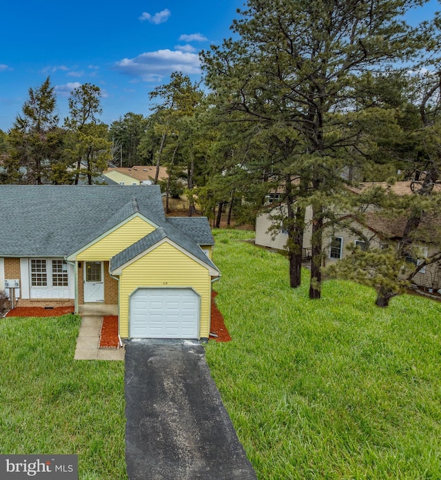 view of front of home featuring an attached garage, brick siding, a shingled roof, driveway, and a front lawn