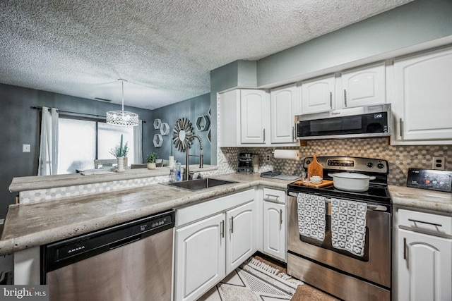 kitchen featuring white cabinetry, stainless steel appliances, and a sink