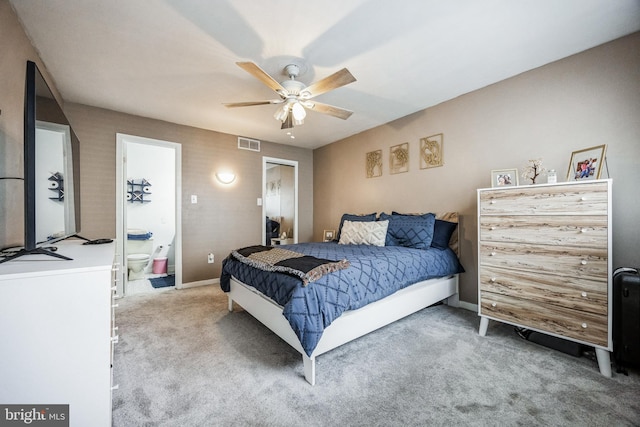 bedroom with visible vents, carpet flooring, ceiling fan, ensuite bath, and baseboards