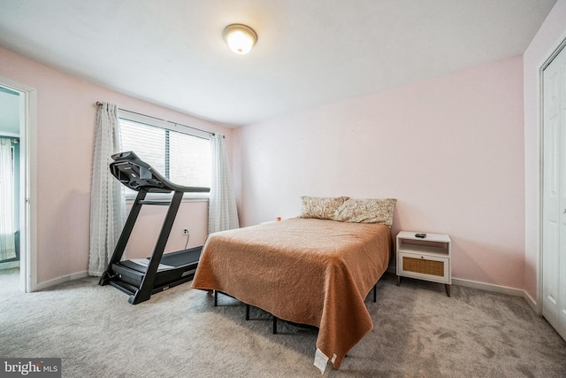 bedroom with light carpet and baseboards