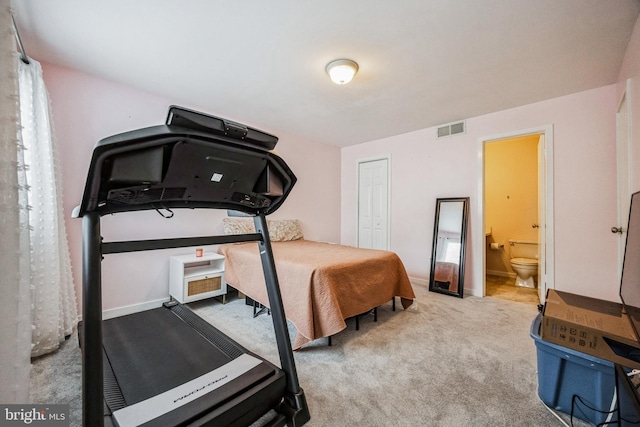 bedroom with connected bathroom, light colored carpet, visible vents, baseboards, and a closet