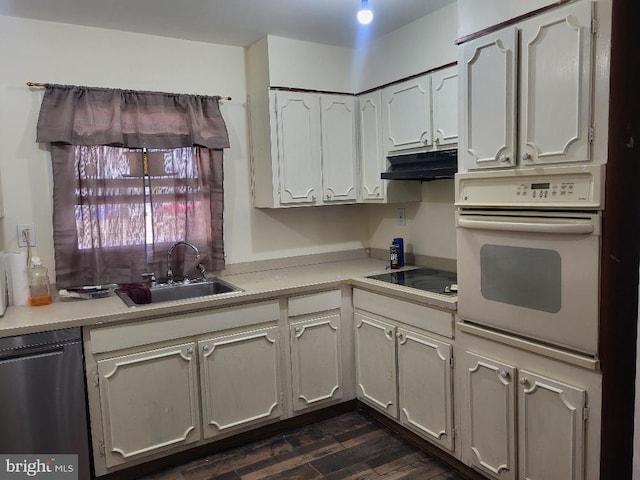 kitchen featuring light countertops, stainless steel dishwasher, a sink, oven, and under cabinet range hood