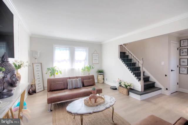 living area featuring crown molding, stairway, baseboards, and wood finished floors