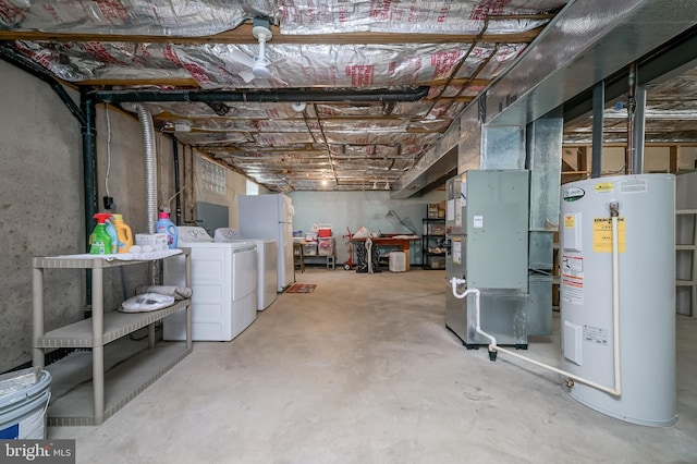 unfinished basement featuring heating unit, water heater, and separate washer and dryer