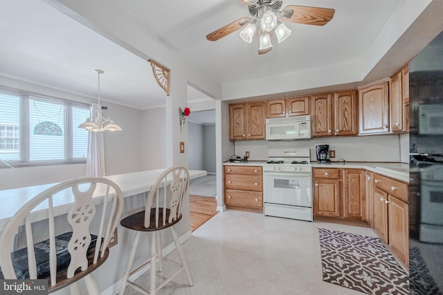 kitchen with white appliances, light floors, hanging light fixtures, light countertops, and ceiling fan with notable chandelier