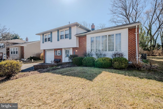 split level home with brick siding, central air condition unit, a chimney, and a front lawn