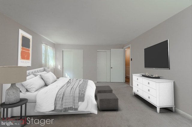 carpeted bedroom featuring multiple closets