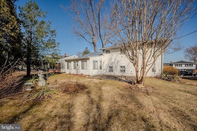 back of house with a yard