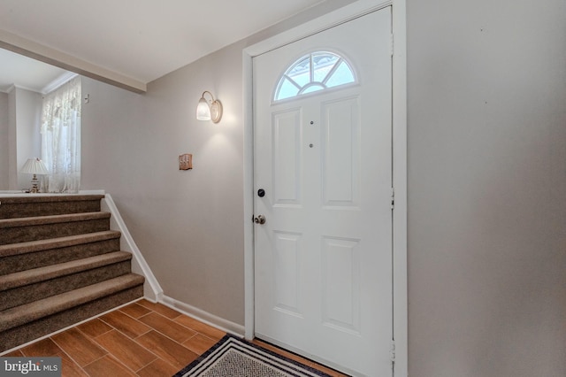 entrance foyer with stairway, baseboards, and wood tiled floor