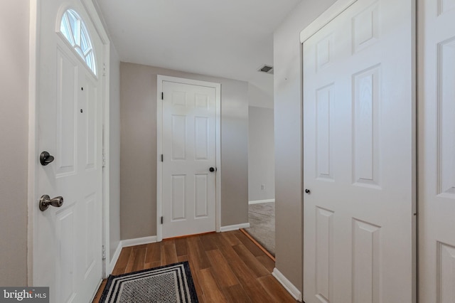 interior space featuring dark wood-style floors, visible vents, and baseboards