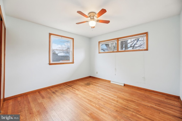 unfurnished room featuring light wood-style floors, baseboards, and a ceiling fan