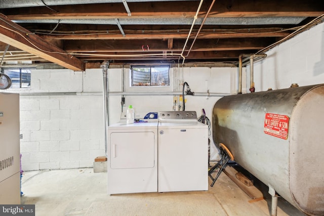 laundry area with washing machine and dryer, laundry area, and heating fuel