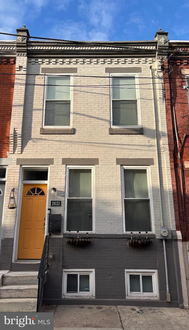 townhome / multi-family property featuring brick siding