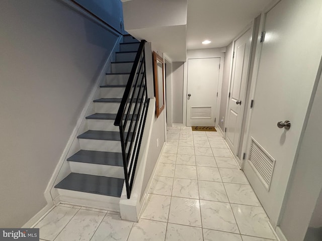 staircase featuring baseboards, marble finish floor, and visible vents