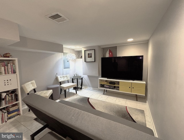 living room featuring baseboards, visible vents, and light tile patterned floors