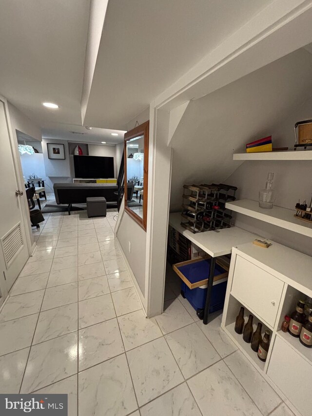 corridor with marble finish floor, visible vents, and recessed lighting