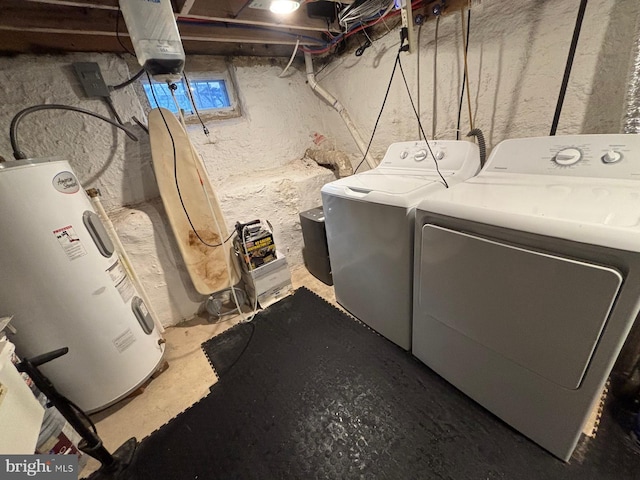 laundry room featuring washing machine and clothes dryer, electric water heater, and laundry area