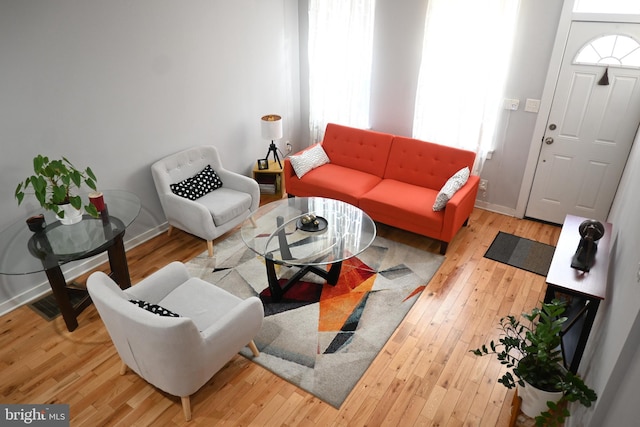 living room featuring baseboards and wood finished floors
