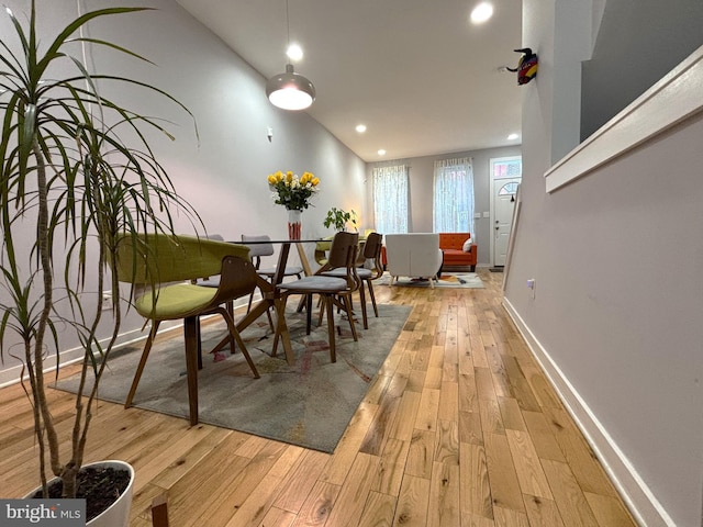 dining room featuring baseboards, recessed lighting, and wood-type flooring
