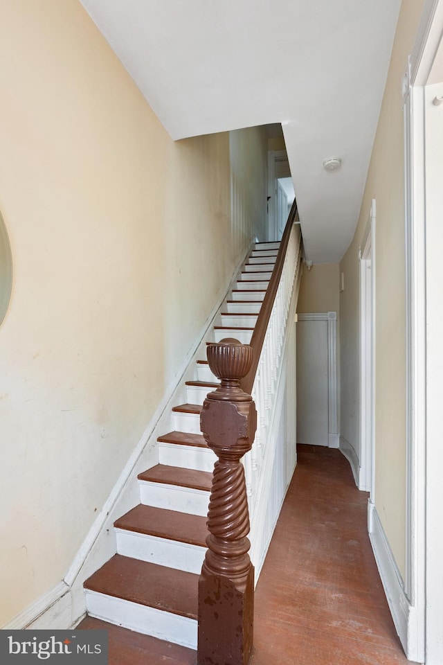 stairway featuring wood finished floors